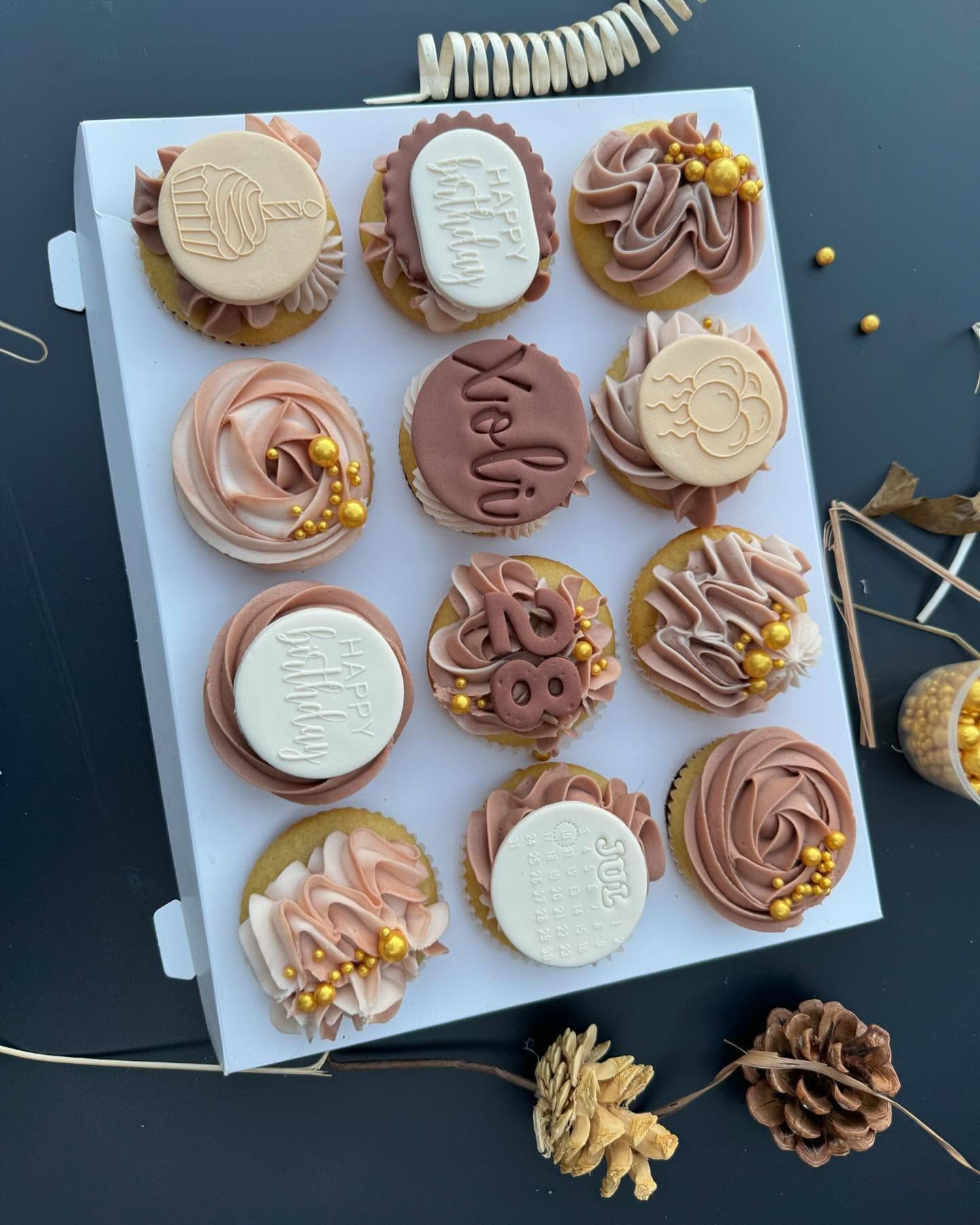 A box of blush buttercream cupcakes
