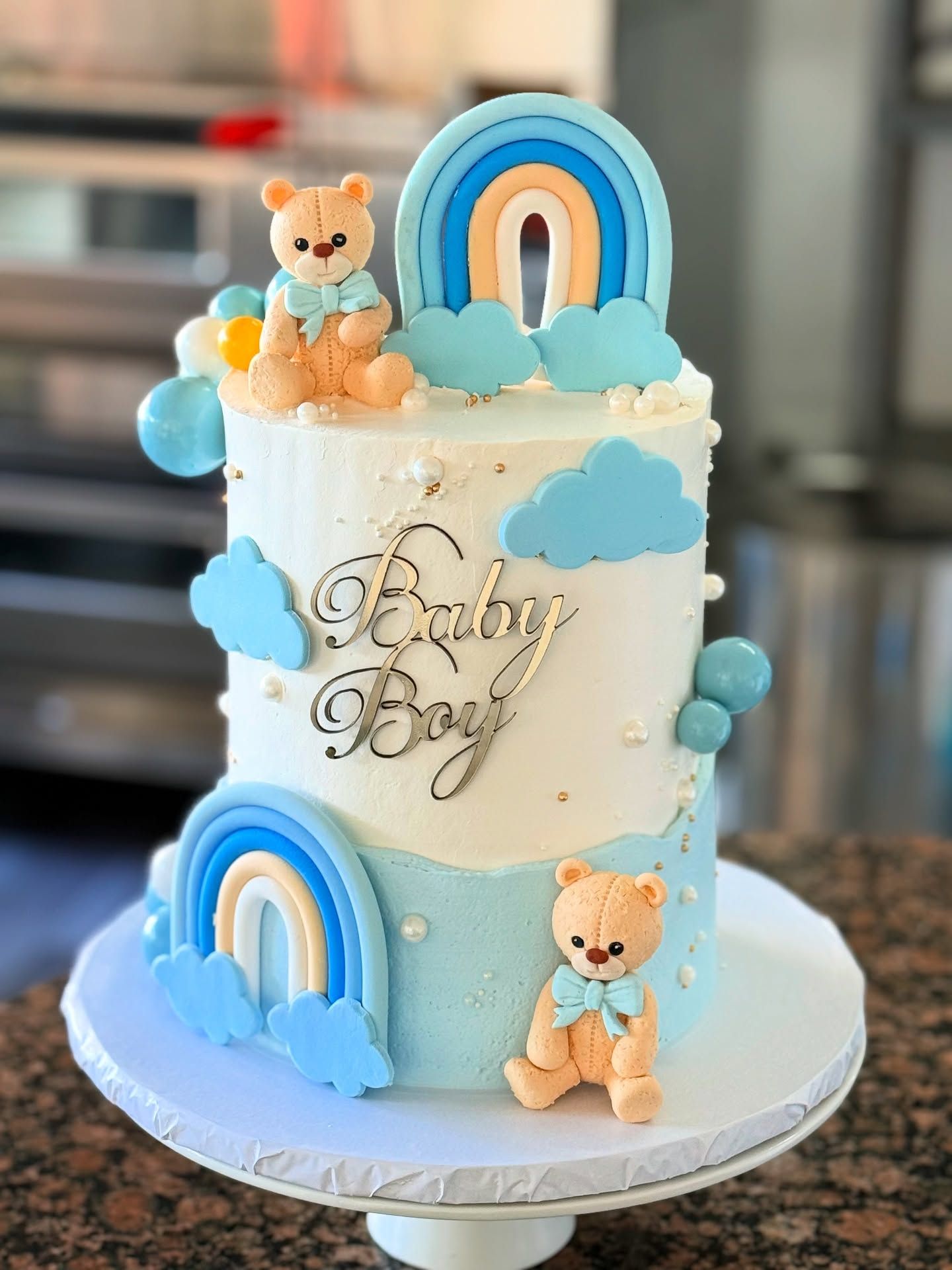 Blue two-tier baby boy celebration cake